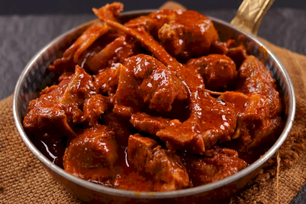 Rogan Josh is a deep, aromatic curry with tender lamb in a rich, spiced yogurt gravy, representing the essence of Kashmiri cuisine with its complex flavors